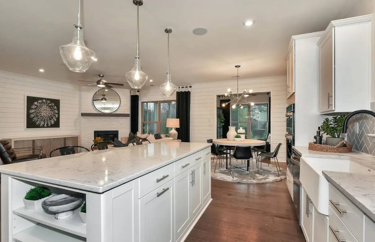 White kitchen with pendant lights and farmhouse sink