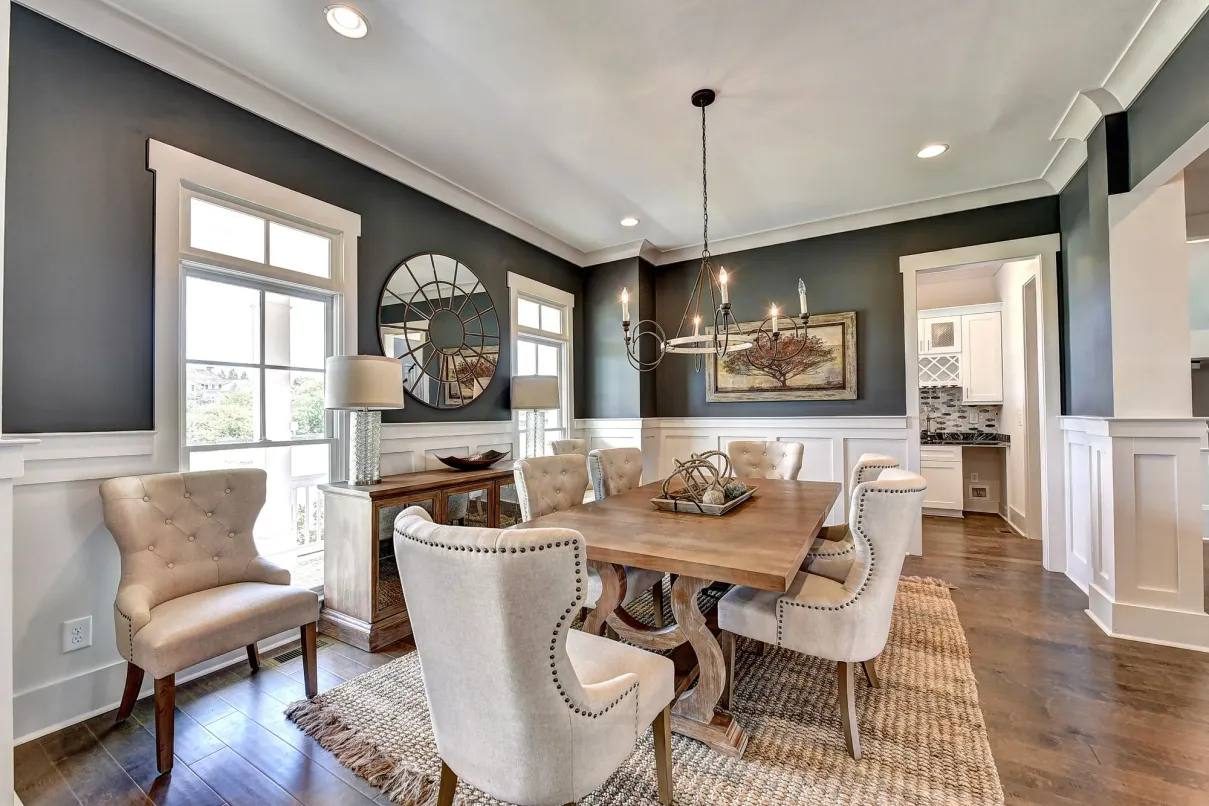Dining room with dark accent walls and wainscoting