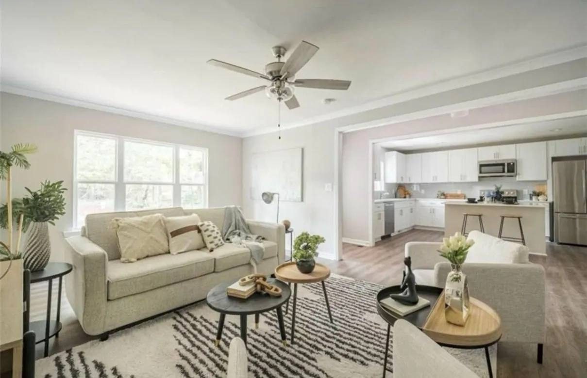Bright open living area with kitchen beyond