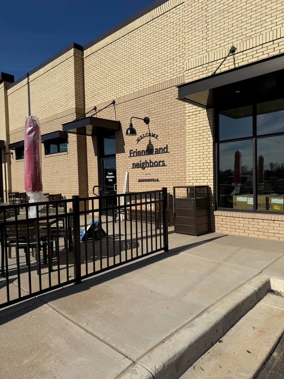 Brick storefront patio with black railing