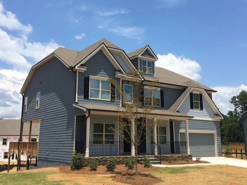Two-story custom home with gray siding and front porch